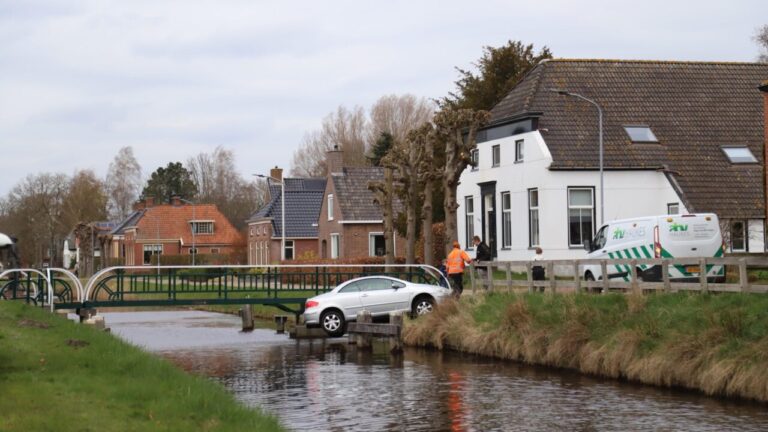 Auto bungelt boven Kieldiep na rollen van oprit