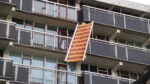 Zonnescherm waait los door storm in Hoogezand