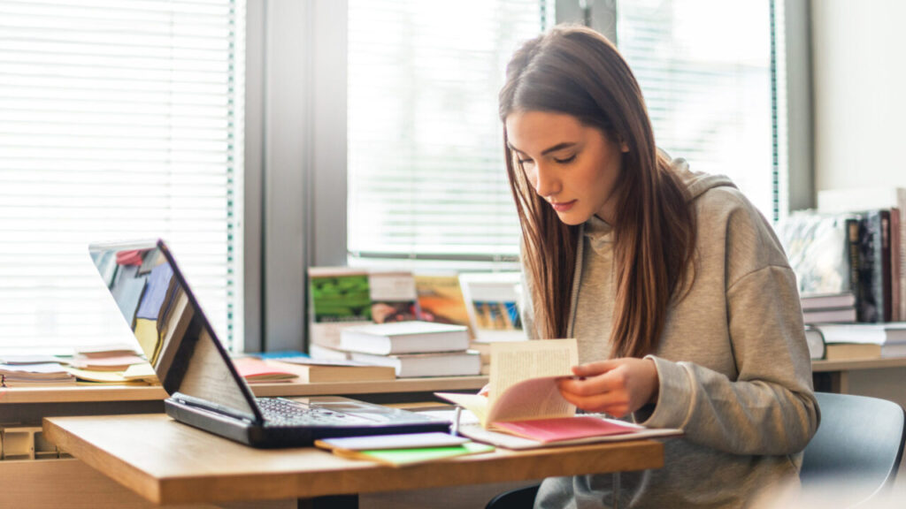 Student aan leren met boeken